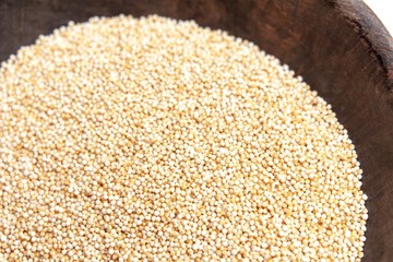 Amaranth puffed in rustic wooden bowl isolated white background