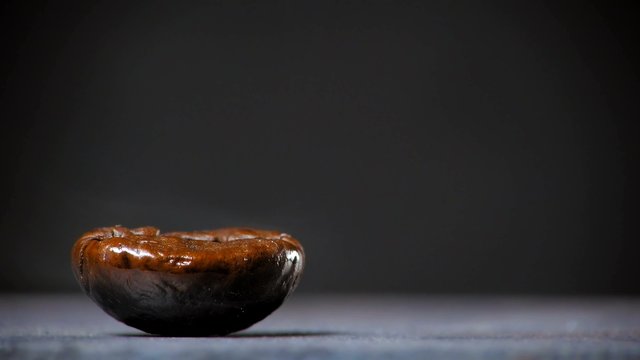 Fried coffee beans with smoke. Close up.