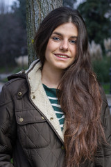 Blue-eyed young model posing in a fashion shoot in the park. 