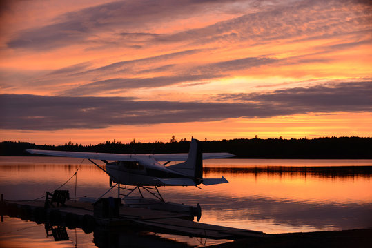 Sunset at an outdoor retreat with a seaplane on a lake