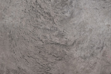 Cement Floor with texture and detailed on the surface plus cracking. The grey tone is from the coating on the floor.
