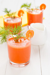 Carrot juice, decorated with sprig of dill