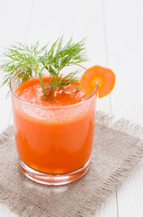 Carrot juice in glasses decorated with dill