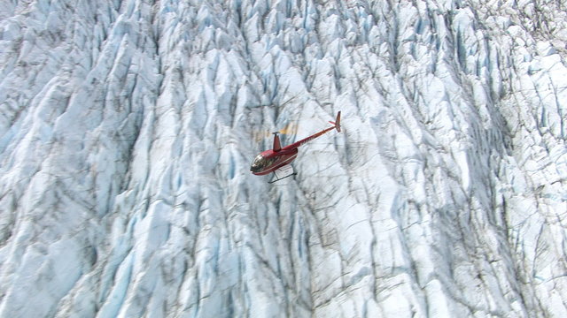 Helicopter flying over glacier in Alaska