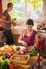 Nice couple cooking together a vegetable meal in the kitchen
