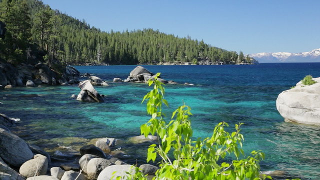 Panning (closer up) and pedestal (wider) views of Bonsai Rock in a small cove on the east shore of Lake Tahoe in Nevada.