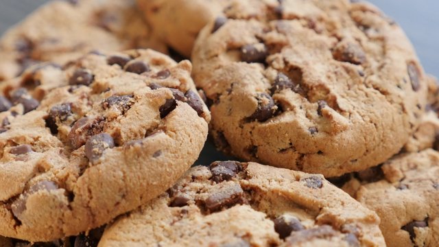 Tasty chocolate chip cake biscuits on the table slow tilt 4K 2160p UltraHD footage - Slow tilting over chocolate cookies on wooden surface 4K 3840X2160 UHD video 