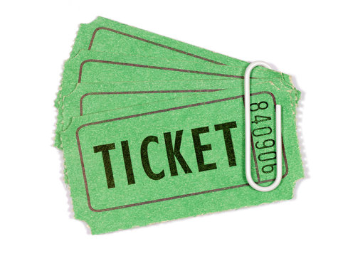 Green movie cinema or theater admission ticket held together with paperclip isolated on white background photo