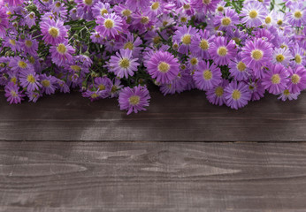 Fototapeta na wymiar Purple cutter flowers are on the wooden background
