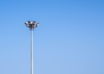 Light pole tower on clear blue sky.