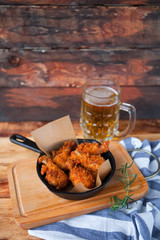 A plate of fresh, hot, crispy fried chicken with red sause on a
