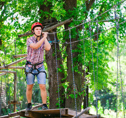 adventure climbing high wire park - people on course in mountain