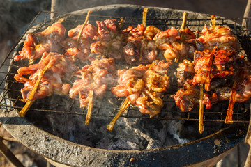 chickens grilled on iron stove, fireplace, Thailand street food.