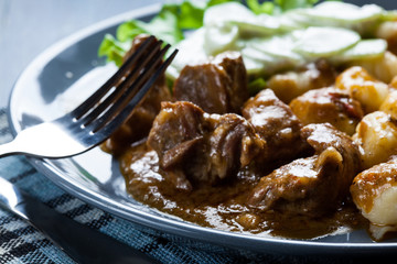 Italian potato dumplings with stew and cucumber salad
