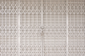 Closed shutters and metal accordion gate of a shoplot