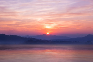 Colorful sunset on top of thailand mountain and lagoon