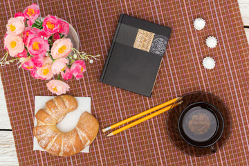 croissant, tea and flowers