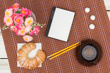 croissant, tea and flowers