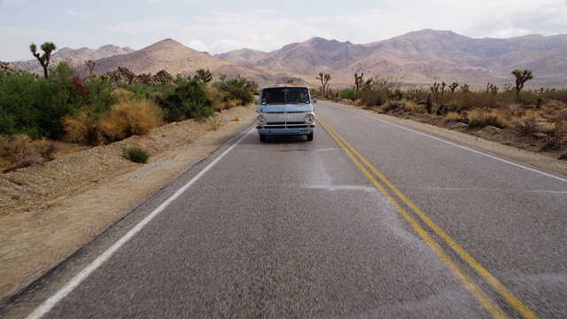 Van driving across desert