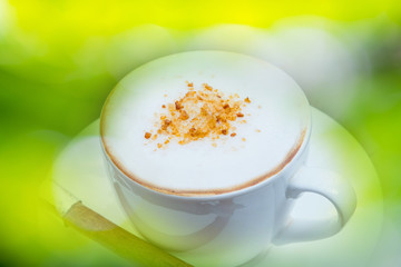 A cup of coffee in a white cup on wooden background