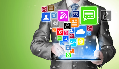 Business man using tablet PC with social media icon set