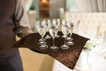 waiter with a tray welcomes visitors