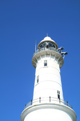 White lighthouse against clear blue sky