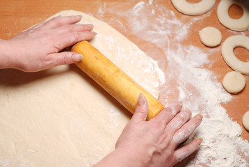 The pastry chef prepares the donuts from dough
