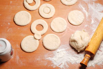 The pastry chef prepares the donuts from dough