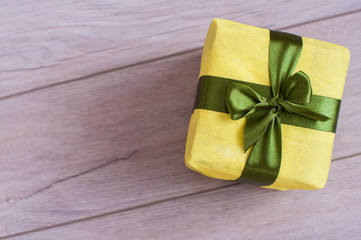 light green gift box on white wood background