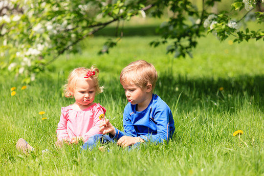 happy kids play with spring flowers