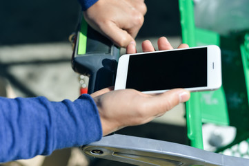Closeup on person holding mobile smartphone in hand during shopping