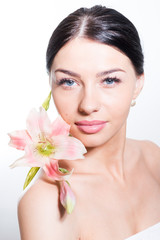 Beautiful lady with lilly flower. Perfect skin.