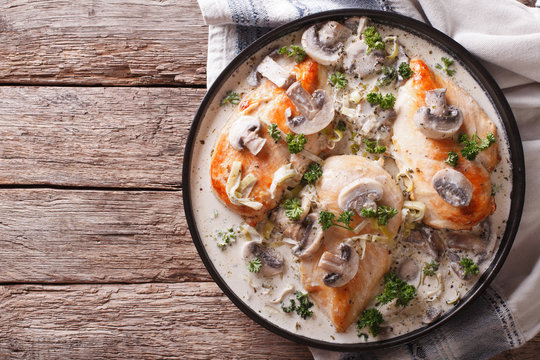 Chicken breast with mushrooms in cream sauce horizontal top view
