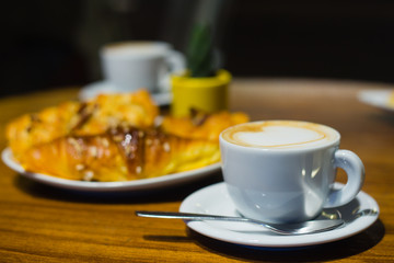 Obraz na płótnie Canvas Morning cup of coffee with croissants
