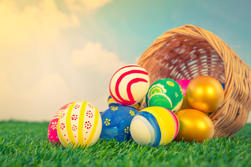 Easter Eggs on Fresh Green Grass over blue sky ( Filtered image