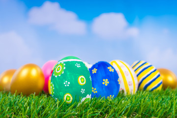 Fototapeta na wymiar Easter Eggs on Fresh Green Grass over blue sky
