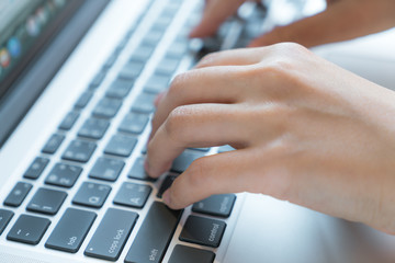 Closeup of business woman hand typing on laptop keyboard..