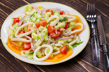 Squid, tomato, onion and greens salad