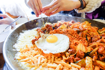 Fried Kim Chi with cheese, pork, egg, vegetables and noodles, Traditional Korean food.