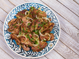 Sauteed chicken liver with apple and onion. View from above, top studio shot
