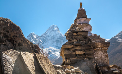 Buddhist stupa and prayer stones in the mountains on the trail.