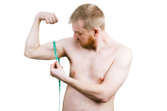 Frustrated bearded man measuring his biceps