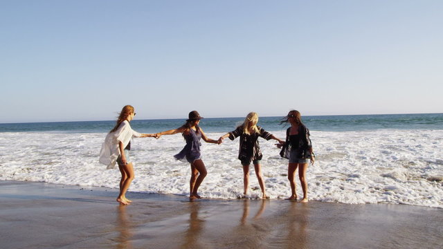 Group of young women at beach, slow motion
