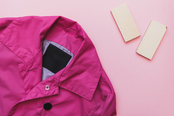 Flat lay fashion set : pink jacket and waffles on pink pastel background