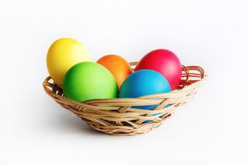Fototapeta na wymiar Bright Easter eggs in basket. Colorful easter eggs.