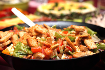 Delicious salad with croutons and vegetables close-up