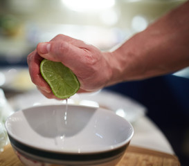 Man squeezing limes