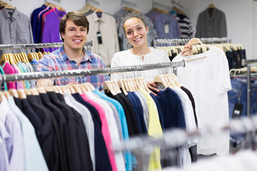 Fototapeta premium pair chooses clothes at the store