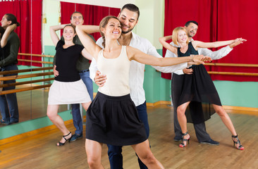 Three happy couples dancing tango